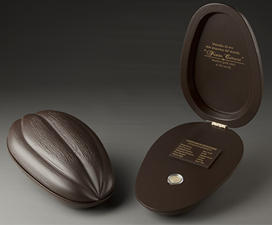 Estuche individual de moneda de la coleccin Fusin cultural Oro, el cual representa una semilla de cacao.